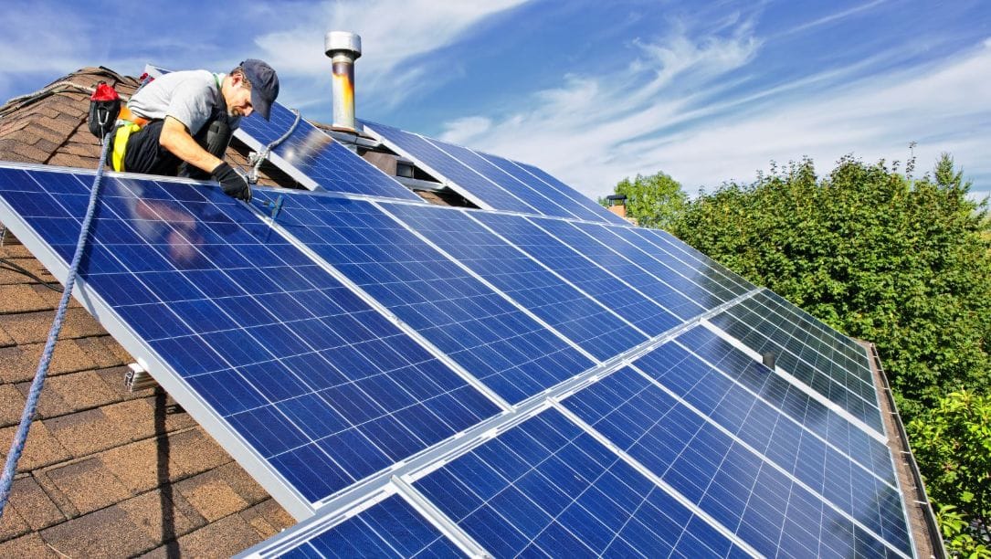 man working on solar panels