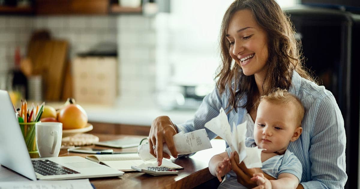 Mom holding child assessing the cost of not going solar